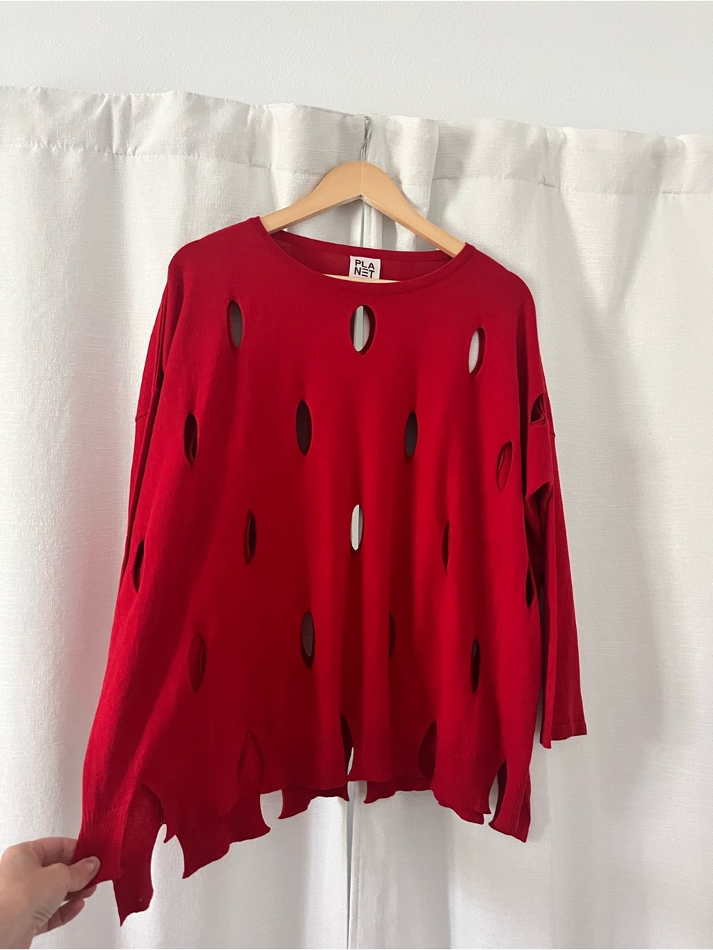 PLANET by Lauren G red, long sleeve top
with intentional cutouts. One size.